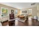 Cozy living room with a leather armchair, sofa, coffee table, and a view to an ensuite bathroom with a tub at 2116 Truffle Ln, Casselberry, FL 32707