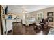 Large bedroom with dark wood floors, a ceiling fan, shuttered windows, and a leather armchair at 2116 Truffle Ln, Casselberry, FL 32707