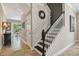 Stairway featuring wood and white banister, tile floors, and view into dining area at 2116 Truffle Ln, Casselberry, FL 32707
