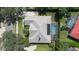 Bird's eye view of a home featuring a tile roof, landscaped yard and screened private pool at 2232 Lake Vilma Dr, Orlando, FL 32835