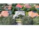 Beautiful aerial view of the house showing the tile roof, mature landscaping and a private screened pool at 2232 Lake Vilma Dr, Orlando, FL 32835