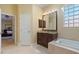 Bathroom showing the soaking tub, granite countertops, and seamless flow to the main bedroom at 2232 Lake Vilma Dr, Orlando, FL 32835