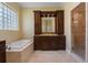 Bathroom features a soaking tub, a glass block window, and a walk-in shower at 2232 Lake Vilma Dr, Orlando, FL 32835