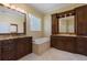 Bright bathroom features double sinks with granite countertops and a luxurious soaking tub at 2232 Lake Vilma Dr, Orlando, FL 32835