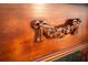 Close up of a wooden cabinet panel shows carved details with roses and leaves at 2232 Lake Vilma Dr, Orlando, FL 32835