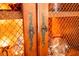 Close-up of decorative cabinet door hardware on wooden shelving unit with mesh backing at 2232 Lake Vilma Dr, Orlando, FL 32835