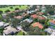 Picturesque aerial view of the community homes with well-maintained landscaping, tile roofs, and community golf course at 2232 Lake Vilma Dr, Orlando, FL 32835