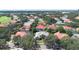 Neighborhood aerial shot showcases tile roofs, landscaping, and a neighborhood golf course at 2232 Lake Vilma Dr, Orlando, FL 32835