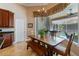 Casual dining area with a wood table and bench seating, complemented by a view of the screened-in pool at 2232 Lake Vilma Dr, Orlando, FL 32835
