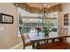 Casual dining area with a wood table and bench seating, complemented by a view of the screened-in pool at 2232 Lake Vilma Dr, Orlando, FL 32835