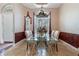 Formal dining room featuring a glass table with ornate chairs, chandelier, and plenty of natural light at 2232 Lake Vilma Dr, Orlando, FL 32835