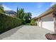 Concrete driveway leading to a two-car garage and the side yard at 2232 Lake Vilma Dr, Orlando, FL 32835