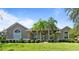 Beautiful single-story home with a well-manicured lawn, palm trees, and lovely landscaping at 2232 Lake Vilma Dr, Orlando, FL 32835