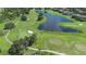 Expansive aerial view of golf course with a lake at 2232 Lake Vilma Dr, Orlando, FL 32835