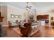 A living room with an open layout, hardwood floors, and decor leading into a kitchen and dining area at 2232 Lake Vilma Dr, Orlando, FL 32835