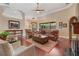Inviting living room features hardwood floors, a ceiling fan, and large windows for natural light at 2232 Lake Vilma Dr, Orlando, FL 32835