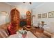 A cozy living room showcasing hardwood floors, leather seating, built-in shelves, and a plant on a table at 2232 Lake Vilma Dr, Orlando, FL 32835