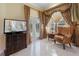 A cozy sitting area is found in the main bedroom with a TV and private pool access at 2232 Lake Vilma Dr, Orlando, FL 32835