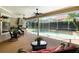 The screened-in patio features comfortable seating and overlooks a sparkling pool and landscaped backyard at 2232 Lake Vilma Dr, Orlando, FL 32835