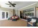 Covered patio with comfortable seating and outdoor living space overlooking sparkling pool at 2232 Lake Vilma Dr, Orlando, FL 32835