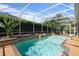This is the stunning screened pool with tropical foliage, and a relaxing spa with a small waterfall feature at 2232 Lake Vilma Dr, Orlando, FL 32835