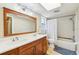 Bathroom with double sink vanity, framed mirror, and shower with tile surround at 2260 Winslow Cir, Casselberry, FL 32707
