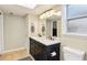 Well-lit bathroom with double sinks, tile floor, and toilet, offering practical comfort and style at 2260 Winslow Cir, Casselberry, FL 32707