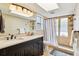 The bathroom offers a double sink vanity, a tiled shower, and modern fixtures for a spa-like experience at 2260 Winslow Cir, Casselberry, FL 32707