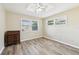 Bright bedroom featuring hardwood floors, a ceiling fan, and two large windows providing ample natural light at 2260 Winslow Cir, Casselberry, FL 32707