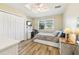Cozy bedroom features a ceiling fan, closet, desk, and a large window at 2260 Winslow Cir, Casselberry, FL 32707