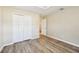 A well-lit bedroom with hardwood floors, a spacious closet, and neutral walls creating a cozy atmosphere at 2260 Winslow Cir, Casselberry, FL 32707