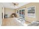 Spacious flex space with tile flooring, a ceiling fan, and sliding glass doors to the backyard at 2260 Winslow Cir, Casselberry, FL 32707