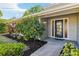 Close up of the home's front door with glass detailing, surrounded by attractive landscaping at 2260 Winslow Cir, Casselberry, FL 32707