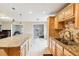 Bright kitchen featuring stainless appliances, granite counters, tile backsplash, and an island at 2260 Winslow Cir, Casselberry, FL 32707