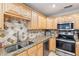 Close-up of kitchen featuring stainless sink, stainless appliances, tile backsplash, and granite countertops at 2260 Winslow Cir, Casselberry, FL 32707