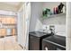 Convenient laundry room with washer, dryer, and built in shelving located near kitchen at 2260 Winslow Cir, Casselberry, FL 32707