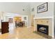 Bright living room featuring a fireplace, tile flooring, and view into the kitchen at 2260 Winslow Cir, Casselberry, FL 32707