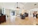 Open living room with vaulted ceiling, tile flooring, and sliding glass doors to the exterior at 2260 Winslow Cir, Casselberry, FL 32707