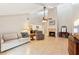 Open living room featuring vaulted ceilings, tile flooring, fireplace, and a ceiling fan at 2260 Winslow Cir, Casselberry, FL 32707