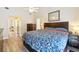 This primary bedroom features a ceiling fan, wood floors, a wood accent wall, and generous closet space at 2260 Winslow Cir, Casselberry, FL 32707