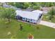Aerial view of a beautifully landscaped property with a screened-in pool at 2369 Haulover Blvd, Deltona, FL 32738