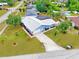 Overhead view of a single-story home, lush landscaping, long driveway, and spacious backyard with a screened in pool at 2369 Haulover Blvd, Deltona, FL 32738
