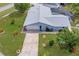 Aerial view of home with screened-in pool, lush landscaping, and a driveway at 2369 Haulover Blvd, Deltona, FL 32738
