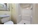 Bathroom features a toilet and a shower with white tiled walls at 2369 Haulover Blvd, Deltona, FL 32738