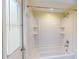 Enclosed tub-shower features a shower head, faucet, and storage shelves at 2369 Haulover Blvd, Deltona, FL 32738