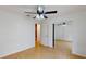 Bedroom boasts light tile flooring, a ceiling fan, and a mirrored closet at 2369 Haulover Blvd, Deltona, FL 32738