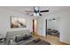 Serene bedroom featuring a ceiling fan, modern decor, and a mirrored closet, with neutral color palette at 2369 Haulover Blvd, Deltona, FL 32738