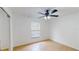 Simple bedroom design features light tile floors, ceiling fan, and window with blinds at 2369 Haulover Blvd, Deltona, FL 32738