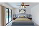 Relaxing bedroom featuring a comfortable bed, stylish decor, and natural light from sliding glass doors to the pool at 2369 Haulover Blvd, Deltona, FL 32738