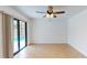 Bedroom with sliding glass door offers pool view and neutral tile flooring at 2369 Haulover Blvd, Deltona, FL 32738
